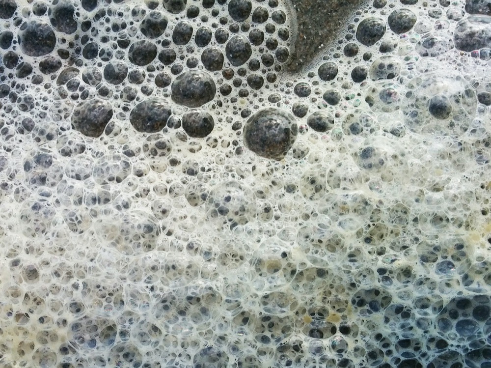Sea Foam On Black Sand - Roma Devanbu